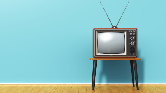 Old retro TV against blue vintage wall in the room